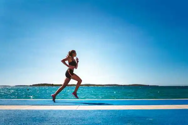 Woman running showing strong leg muscle Ripley